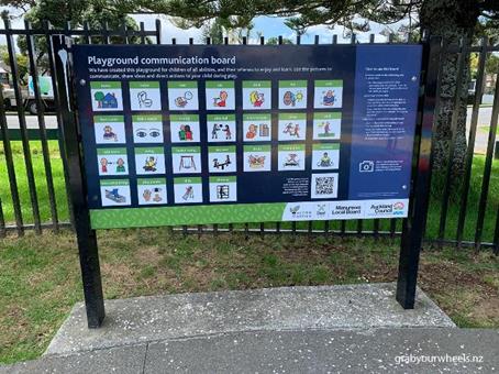 A Communication Board in situ containing words complimented with pictures incorporating New Zealand sign language for children of all-abilities to communicate. It includes words that would be commonly used at a playground such as see-saw, house and toilet