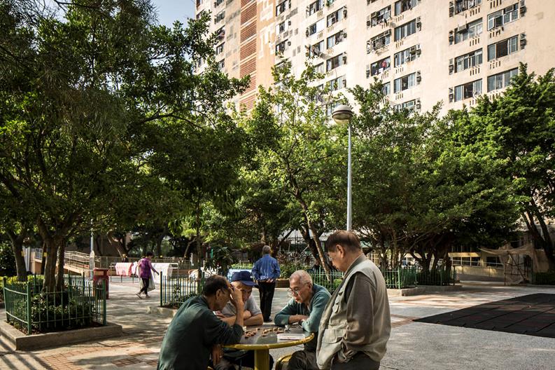 A group of older persons playing draughts in Kwai Shing, a public housing neighbourhood in Hong Kong.